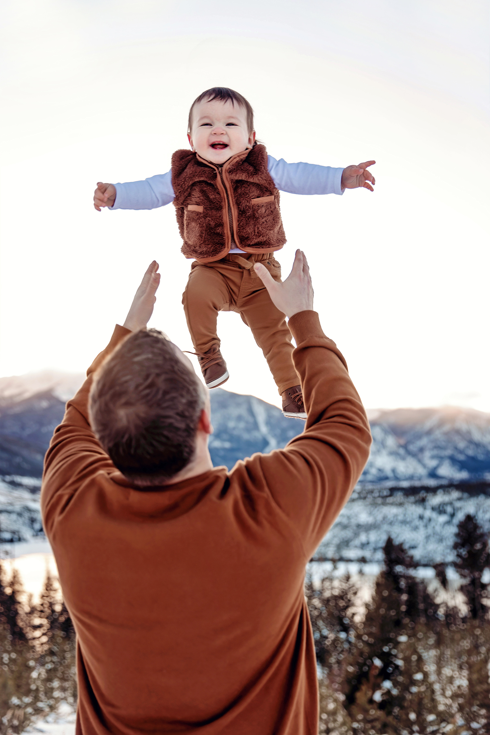 Dad throwing baby in the air